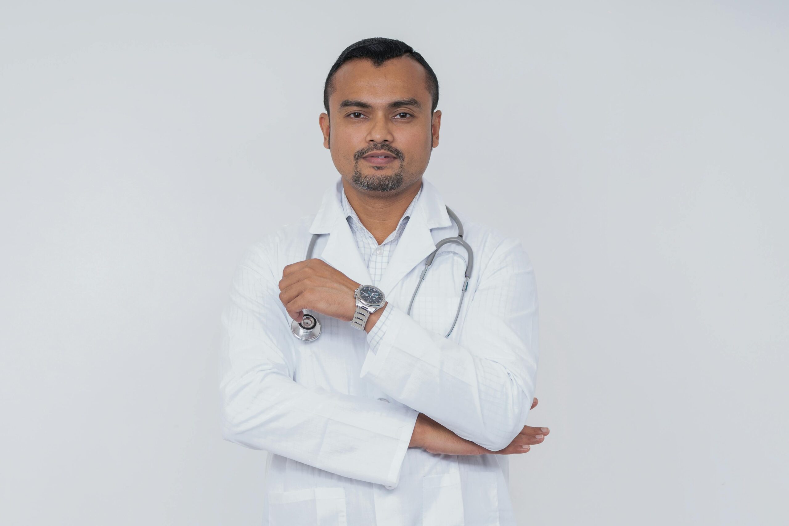 Portrait of a confident doctor in a white coat with a stethoscope, symbolizing healthcare professionalism.